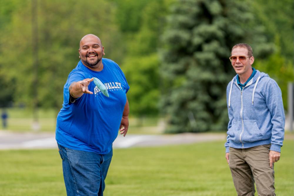 A player throws a bag and smiles during a game